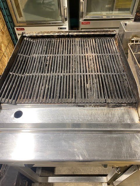 Used Restaurant Equipment Therma-Tek 24" Natural Gas Charbroiler on a work stand TC24-CL